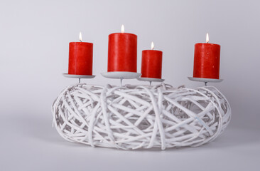 Festive image of four red burning candles on a white wreath, perfect for Christmas, celebration, and holiday themes. A symbol of warmth, light,