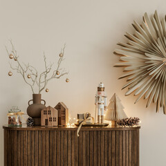 Christmas sideboard with nutcracker, wooden houses and fairy lights. Warm neutral palette and cozy Scandinavian holiday feel.