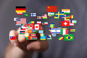 A hand pointing at various international flags interconnected, symbolizing global communication,...