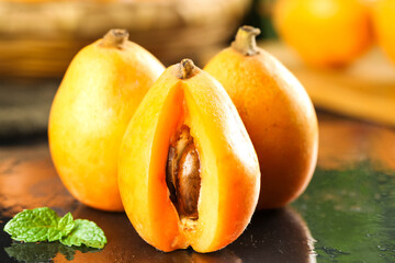 Fresh Ripe Loquat Fruit Cut in Half Showing Seeds and Golden Flesh