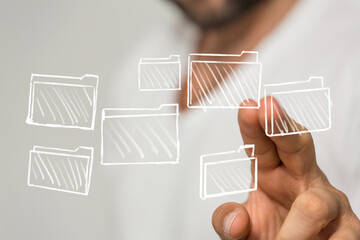 Person interacts with virtual files, showcasing data organization, management, and cloud storage concepts.