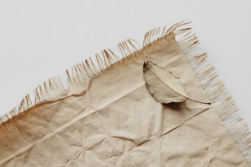 Woven natural fiber mat with fringed edges and a folded section, earthy tones.