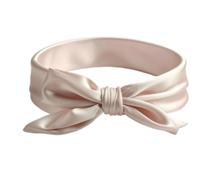 A pale peach satin headband with a large bow