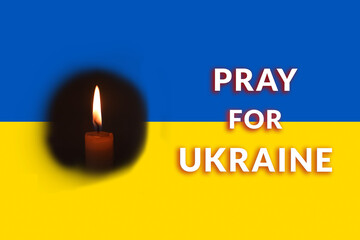  support for Ukraine. Text PRAY for Ukraine on the Ukrainian blue and yellow flag background. Flame candle