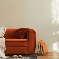 Stylish interior of living room at fancy home with design sofa, newspaper stand, pillow, blanket,...