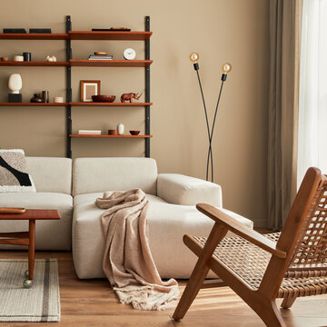 Modern interior of living room with design modular beige sofa, coffee table,  furniture, pendant lamp, shelf, slippers, carpet, decoration and elegant personal accessories in home decor. Template.