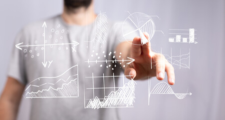A person pointing at data charts and graphs representing financial data, analytics, and business intelligence in a modern digital environment.