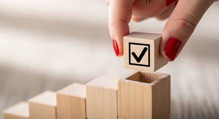 Hand placing checked wooden block on step creating a checklist progress completion success concept