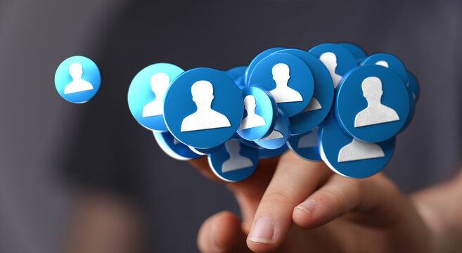 A hand holding a cluster of social media profile icons, representing connections, networking, and community in the digital world. Concepts inclu