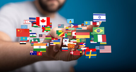 Concept image of human hand holding flags of different countries symbolizing globalism,...