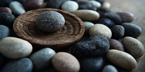 Zen arrangement of stones on wooden plate with balance and harmony for meditation and spa wellness design - AI generated