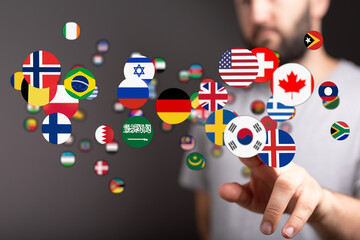Image showing a hand interacting with floating country flags, symbolizing globalization,...