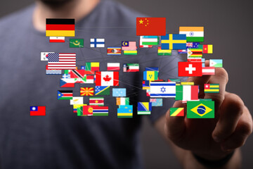 Concept image of a hand interacting with numerous national flags, symbolizing global connection, collaboration, and international unity. Represe