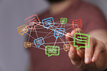 Hand touching abstract network of communication bubbles, representing connectivity, social media, and digital interaction.