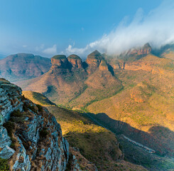 A view past the rocky side of Blyde River Canyon towards three Rondavels,  Mpumalanga, South Africa in Springtime