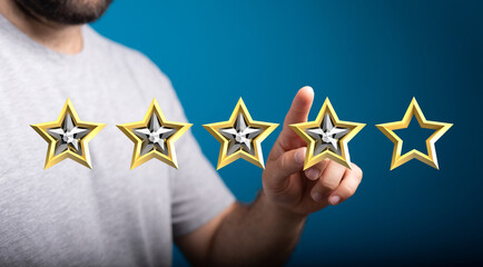 A person pointing at a star rating system, representing customer feedback, satisfaction and...