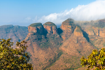 A view between trees towards three Rondavels in Blyde River Canyon,  Mpumalanga, South Africa in Springtime