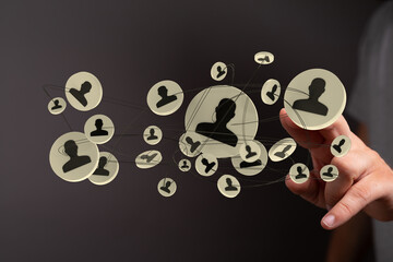 Hand reaching to the social network with person icons, a concept of connection, teamwork,...