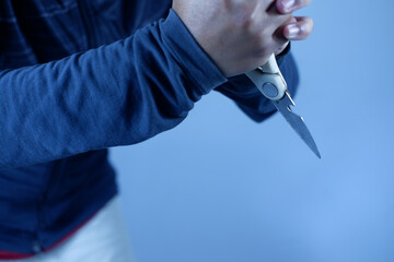 Dangerous Man Holding Sharp Scissors in the Dark, Murder Concept. Scissors in a man's hand attack...