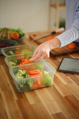 Closeup attractive woman arranging her dividing food into meals