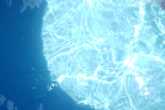 A serene, top-down view of shimmering blue water with sunlit ripples, creating a beautiful abstract pattern. The clear surface evokes feelings of calmness, purity, and refreshment.

 - Powered by Adobe