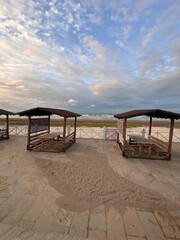 Peaceful sea with soft waves and autumn colors along the beach.

