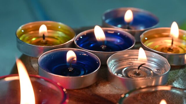happy diwali - colorful glass diya lamps lit during diwali celebration, pattern of colorful celebration candles.