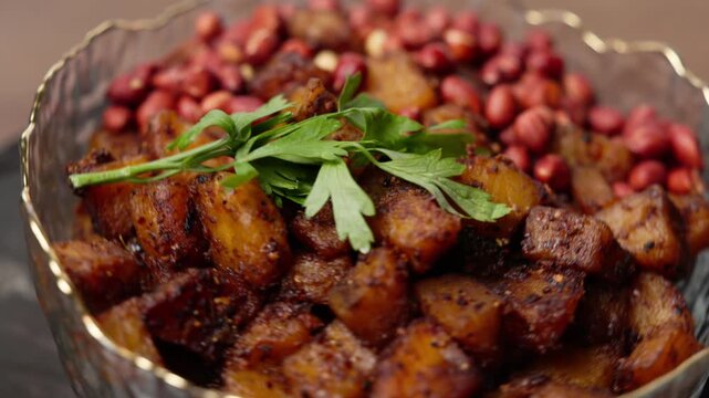 Kelewele, Fried Ripe Plantain Seasoned with Ginger, Cloves, and Pepper, Served with Roasted Groundnuts, a Popular Spicy Ghanaian Snack
