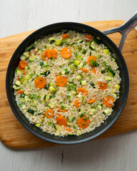 Rice paella with vegetables and salmon. Step-by-step recipe to learn how to cook.