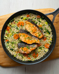 Rice paella with vegetables and salmon. Step-by-step recipe to learn how to cook.