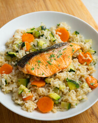 Rice paella with vegetables and salmon. Step-by-step recipe to learn how to cook.