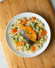 Rice paella with vegetables and salmon. Step-by-step recipe to learn how to cook.