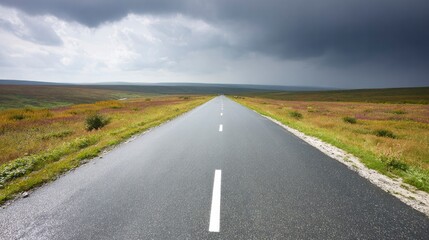 Obraz premium Moody overcast sky over an expansive empty roadway with atmospheric depth.