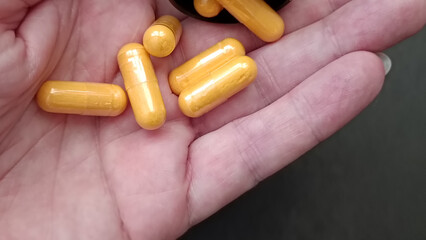 six yellow pills in the left hand