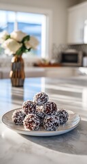 Naklejka premium Delicious chocolate coconut balls on a plate in a bright, modern kitchen, perfect for healthy snacking or a sweet treat after dinner with family and friends
