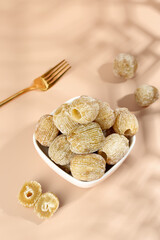 Dried Jujube Fruits in White Bowl with Golden Fork - Traditional Chinese Preserved Fruit Snack