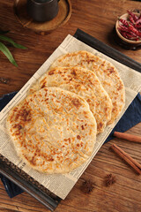 Traditional Asian Scallion Pancakes on Newspaper with Spices and Tea - Authentic Cooking Style