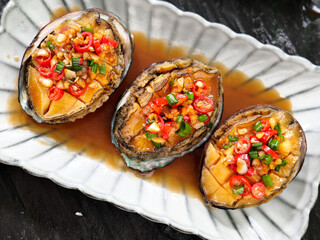 Steamed Abalone with Garlic and Chili Peppers on Shell Plate - Premium Asian Seafood Delicacy