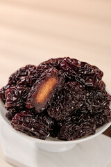 Large Black Dried Jujube Dates from Xinjiang Shaanxi China in White Bowl