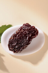 Chinese Black Jujube Dried Fruit from Xinjiang Shaanxi Regions on White Plate