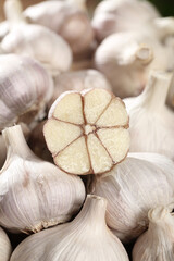 Fototapeta premium Fresh Shandong Farm Garlic Bulbs with Cut Cross-Section Showing Cloves