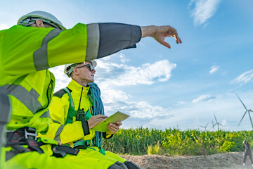 Team of engineers in reflective work suits join hands to inspect and demonstrate their work and...
