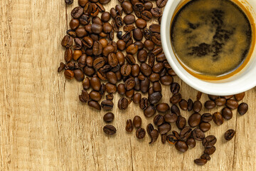 Rising Coffee Prices Concept with Cup and Spilled Coffee Beans on Wooden Table
