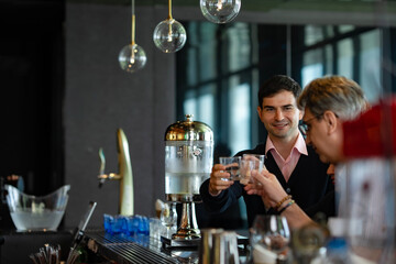 Business professionals enjoying after-work drinks at rooftop bar, networking and celebrating success, concept of teamwork, corporate friendship, and modern business lifestyle.