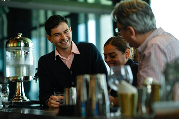 Smiling entrepreneurs clinking glasses at after-work party in rooftop setting, concept of professional success, friendship, and positive business relationships.
