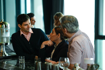 Group of business colleagues enjoying social gathering at elegant bar, symbolizing corporate culture, team celebration, and modern lifestyle balance.