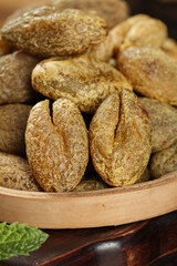 Dried Chaoshan Candied Olives with Pits in Wooden Bowl - Traditional Chinese Preserved Fruits Snack