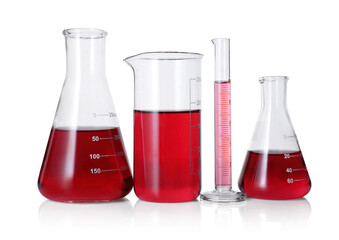 Different laboratory glassware with red liquid isolated on white
