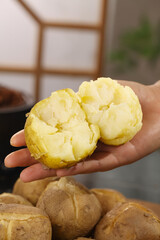 Fresh Steamed White Potato Hearts and Taro Root in Hand - Traditional Asian Cooking