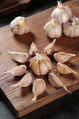 Fresh Garlic Bulbs and Cloves on Wooden Cutting Board - Natural Cooking Ingredients